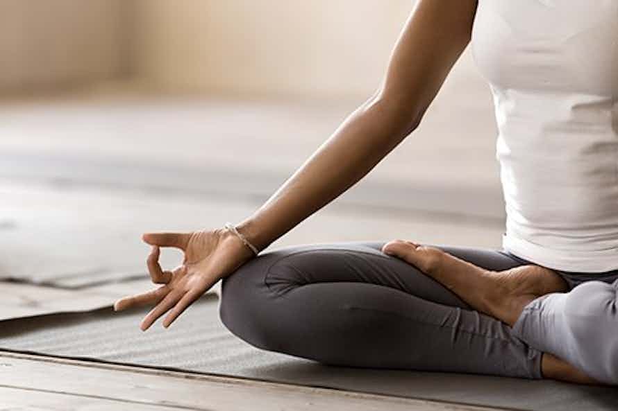Woman participating in yoga as part of a workplace wellness program